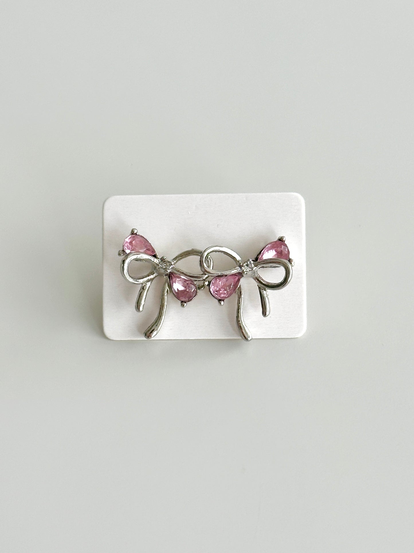 Silver bow pink earring