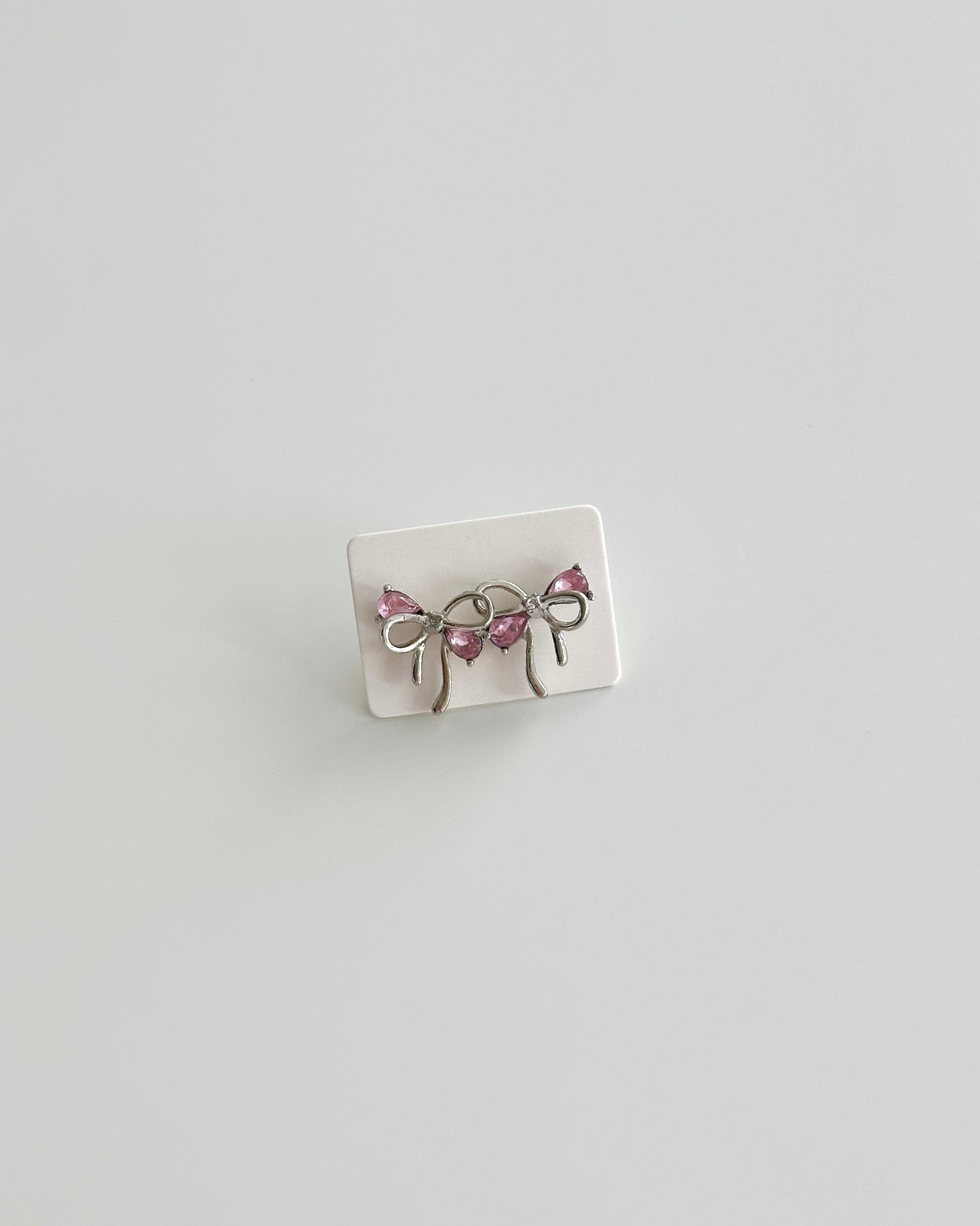 Silver bow pink earring